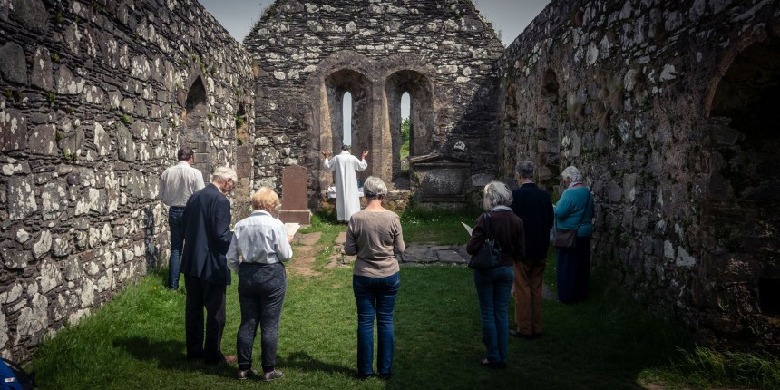 An open air service in the abandoned Kidalton Old Parish church.